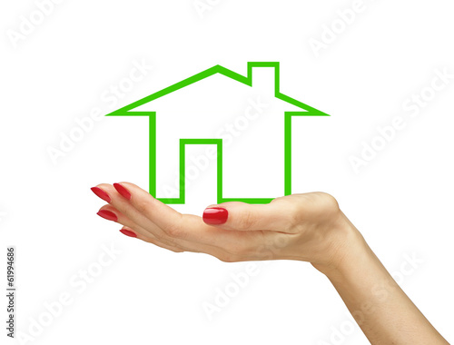 Green house in woman hand isolated on white background. Real est