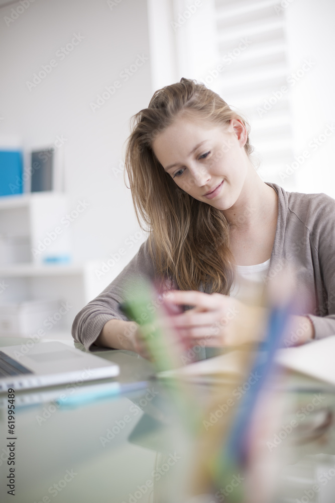 beautiful young woman on the workplace using his phone beautiful young woman on the workplace using his phone