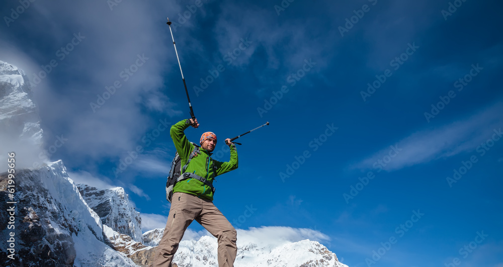 Hiker posing in Himalayas in front of big mountains