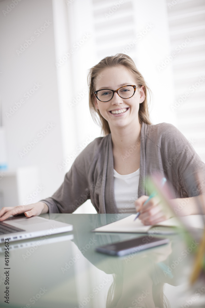 beautiful young woman working on her laptop in her office beautiful young woman working on her laptop in her office