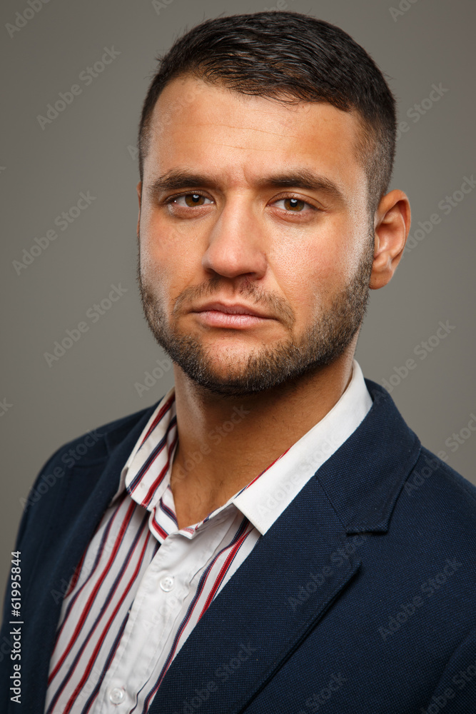 Serious adult man on a gray background Serious adult man on a gray background