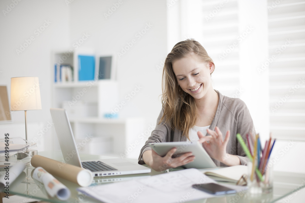 beautiful young woman on the workplace using a digital tablet beautiful young woman on the workplace using a digital tablet