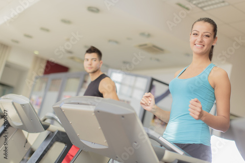 Young man and woman training in the gym
