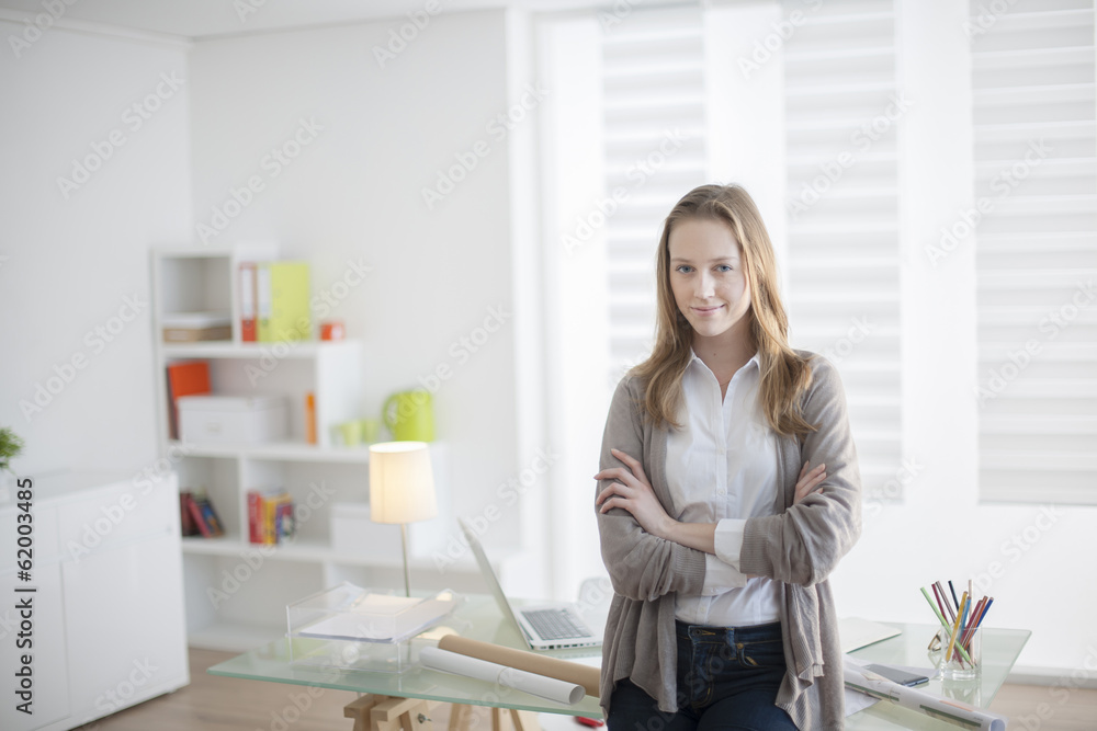beautiful young woman arms crossed standing in front of his desk beautiful young woman arms crossed standing in front of his desk