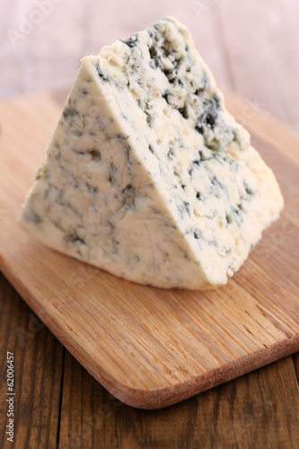 Tasty blue cheese, on wooden table