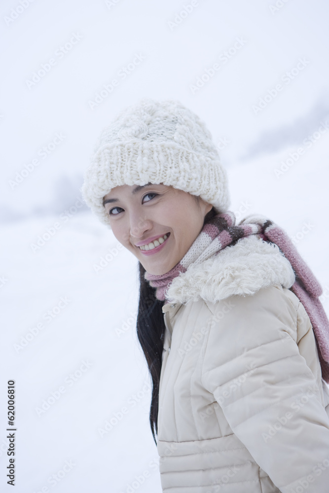 woman standing still in snowy field woman standing still in snowy field