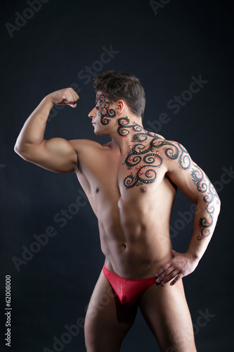 Image of muscular guy posing with pattern on body