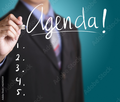 Businessman writing agenda