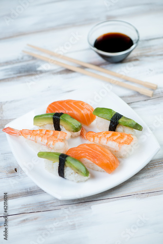 Sushi with salmon, shrimp and avocado, vertical shot