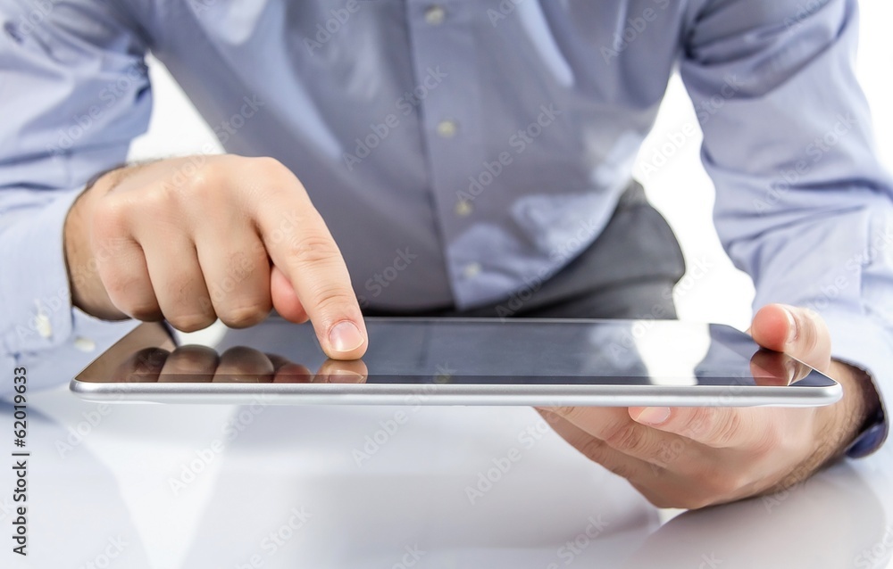 Man fingers touching screen on digital tablet Man fingers touching screen on digital tablet