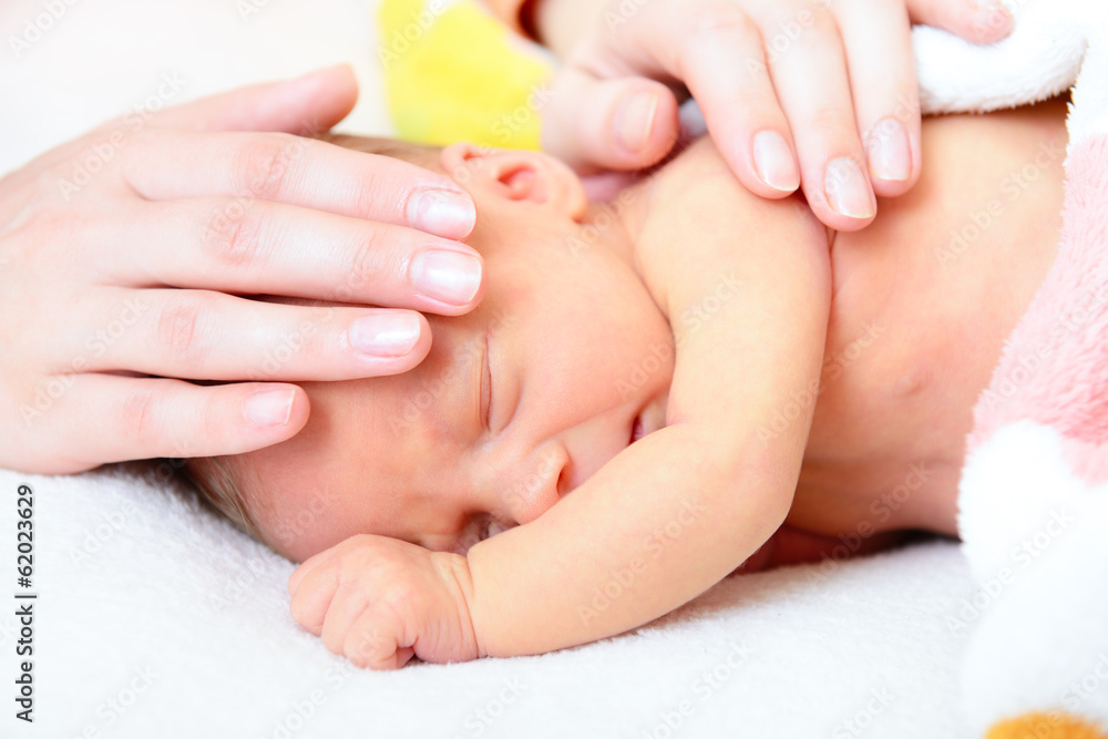 mothercare, cute newborn baby with young mother's hands mothercare, cute newborn baby with young mother's hands