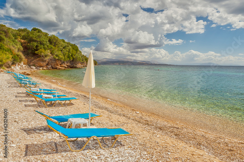 Empty beach Lounge chairs under bright sunlight