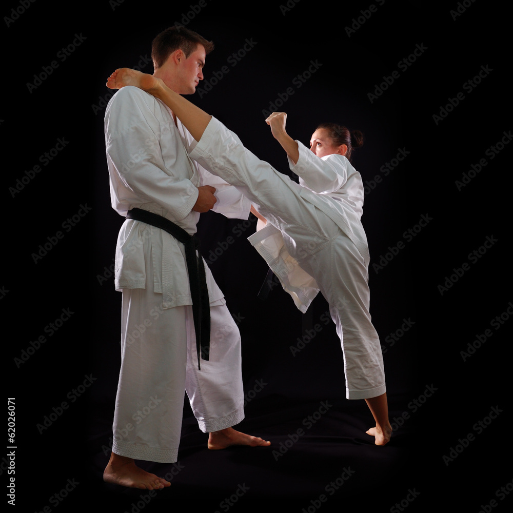fighting karate couple, man and woman with black belts - champio fighting karate couple, man and woman with black belts - champio
