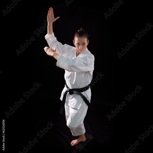 karate girl with black belt posing, champion of the world, on bl