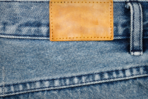 Fototapeta Label sewed on a blue jeans