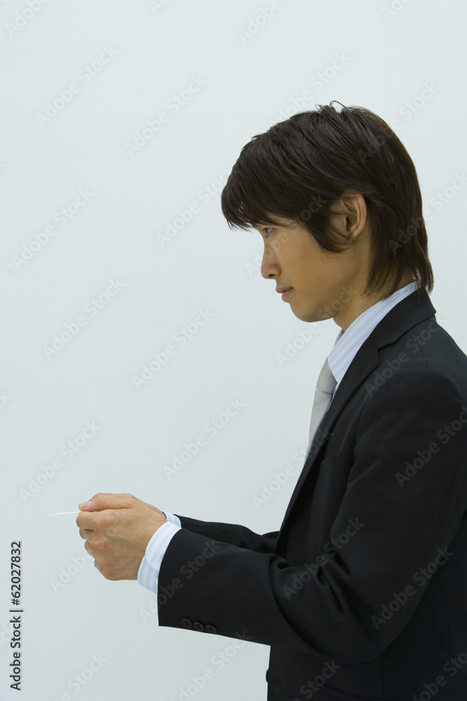 man handing business card
