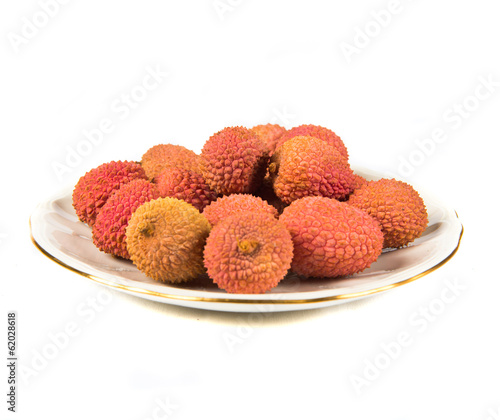 plate with rambutan isolated over white background