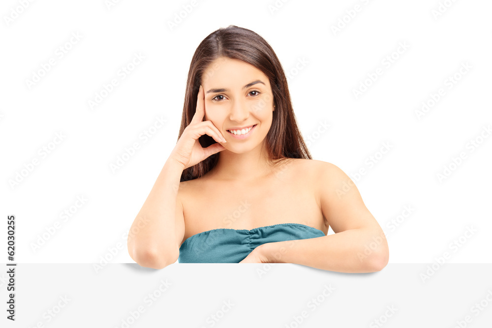 Young girl posing behind a blank panel Young girl posing behind a blank panel