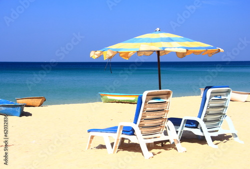 clear blue sky with beach umbrella