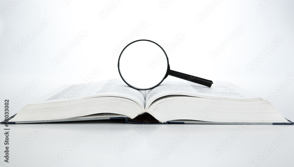 open book with loupe Stock Photo | Adobe Stock