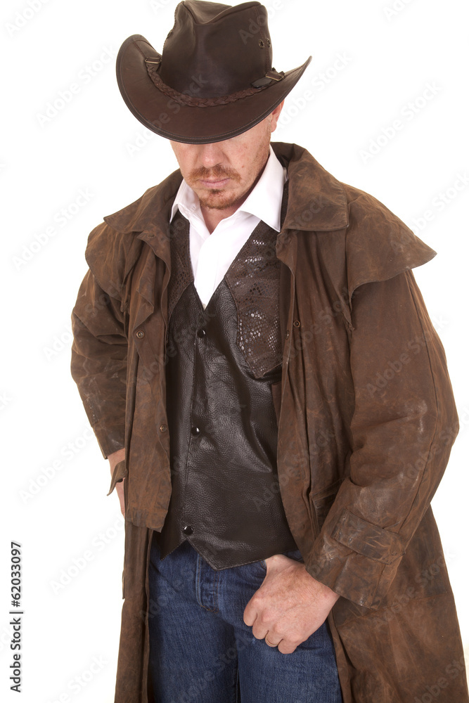 Cowboy in vest and duster hat cover eyes look down Cowboy in vest and duster hat cover eyes look down