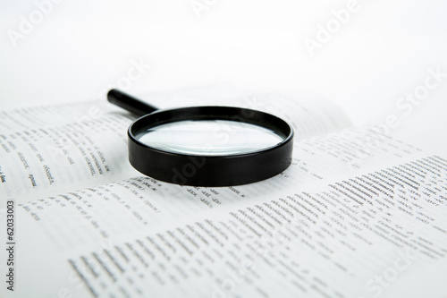open book with loupe closeup