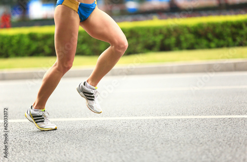 marathon athletes legs running on street  © lzf