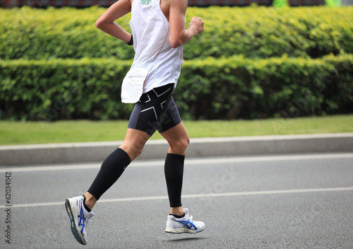 marathon athletes legs running on street 