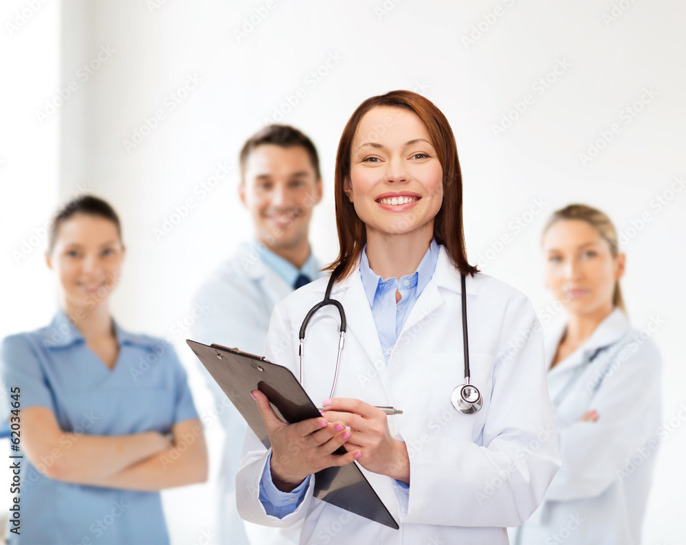 smiling female doctor with clipboard smiling female doctor with clipboard