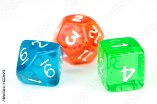 Three colorful translucent dice, on white