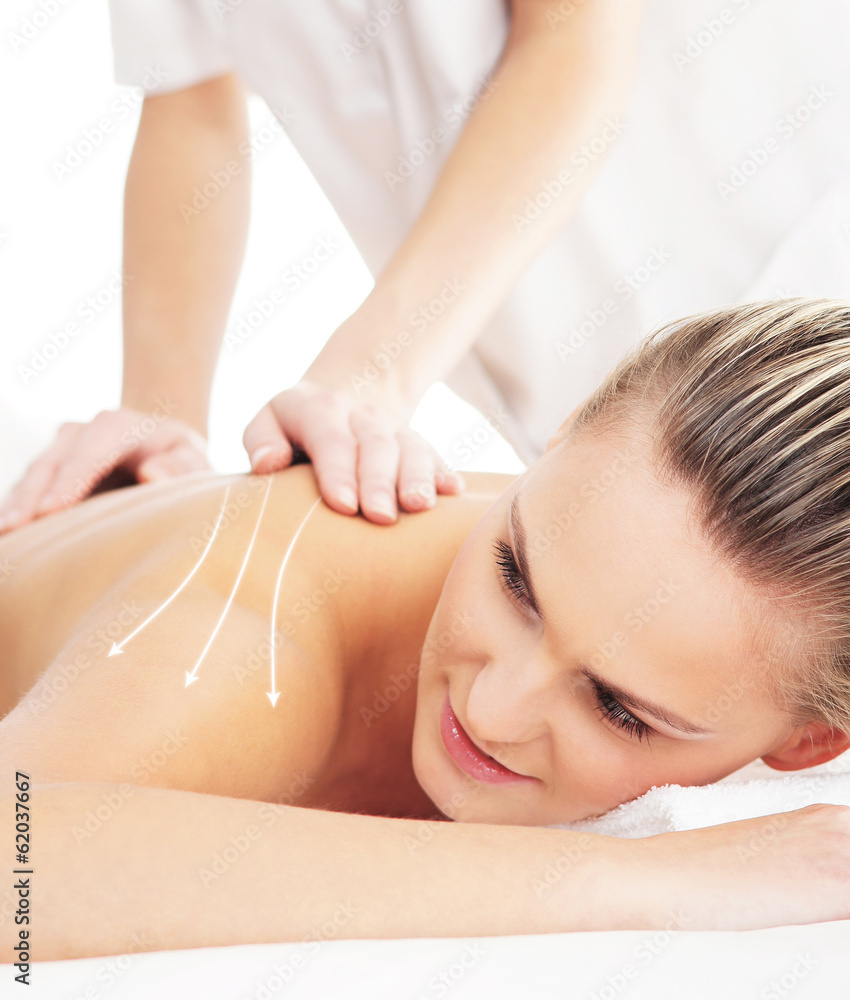 Back of a woman getting spa treatment from a therapist Back of a woman getting spa treatment from a therapist
