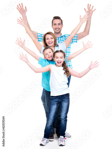 Young happy family with children raised hands up
