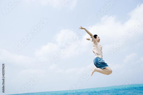 woman jumping on beach