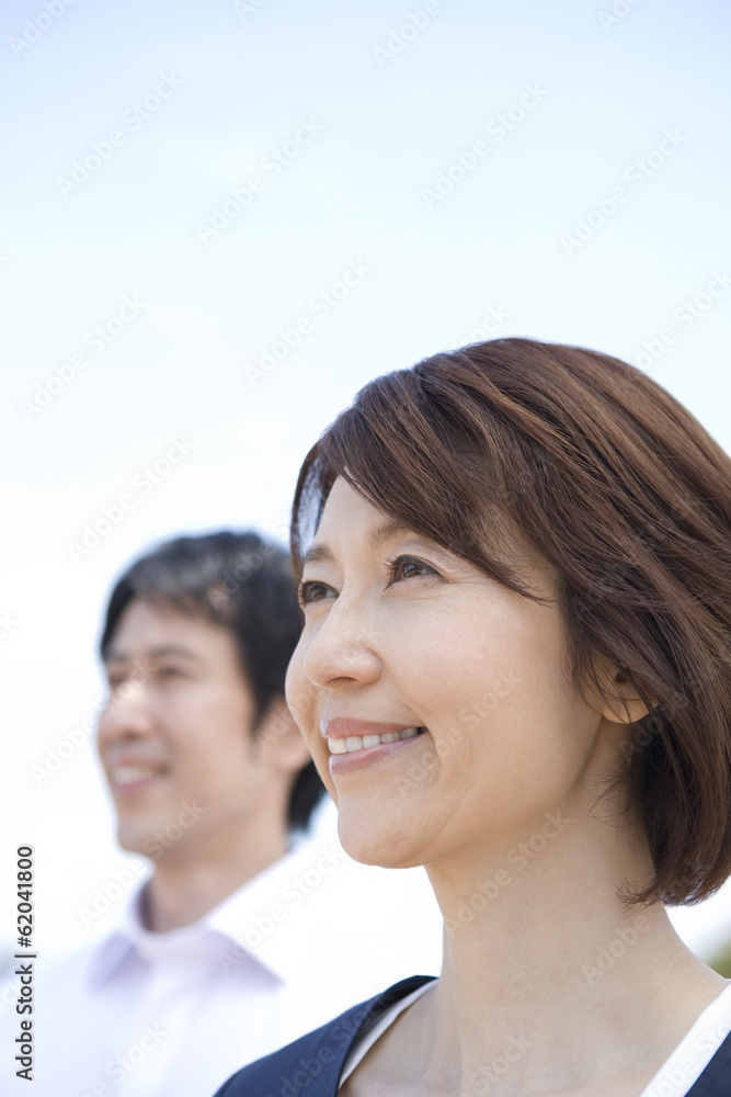woman smiling with her back against blue sea woman smiling with her back against blue sea