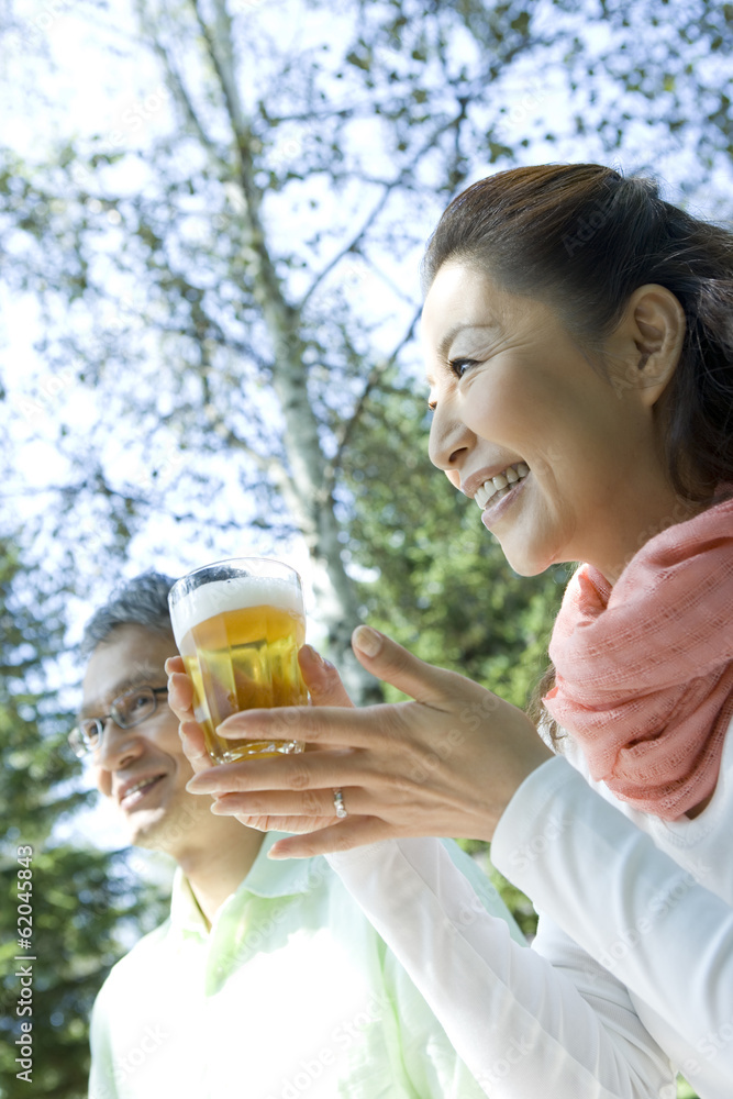 senior woman with glass of beer senior woman with glass of beer