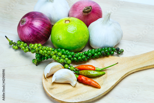 Fototapeta Naklejka Na Ścianę i Meble -  Spicy herbs on wooden ladle and chopping board