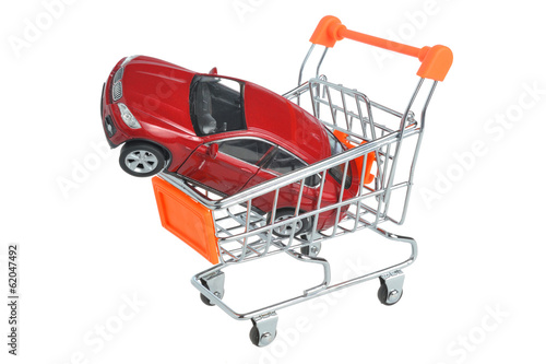 Toy car in shopping cart isolated on white