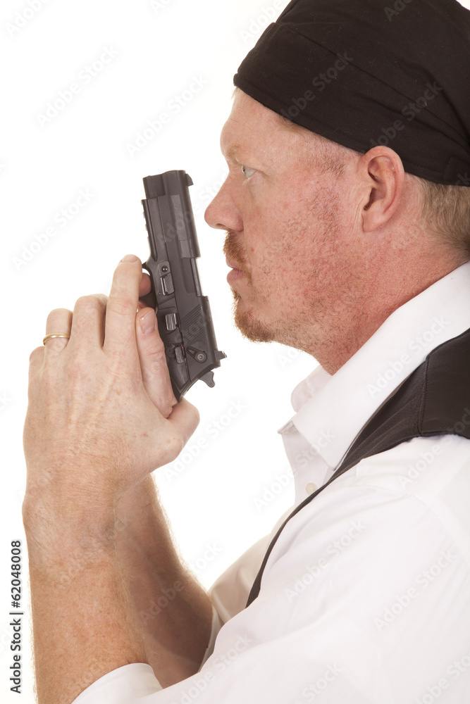 Man bandana on head gun close profile Man bandana on head gun close profile