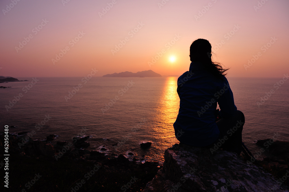 hiking woman enjoy the sunrise seaside