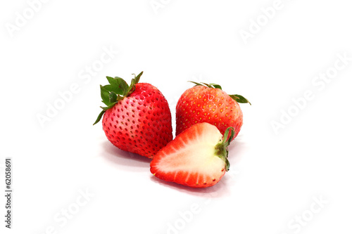 Fresh ripe strawberries and slice on white background