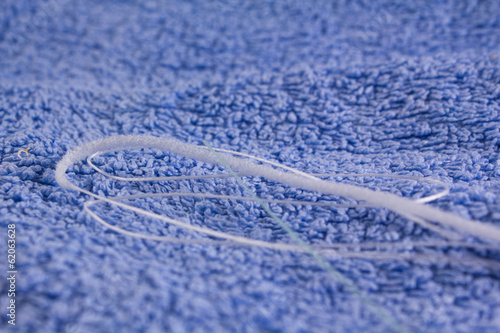 dental floss on a blue towel