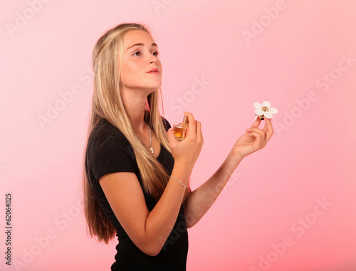 Blonde teenager applying perfume