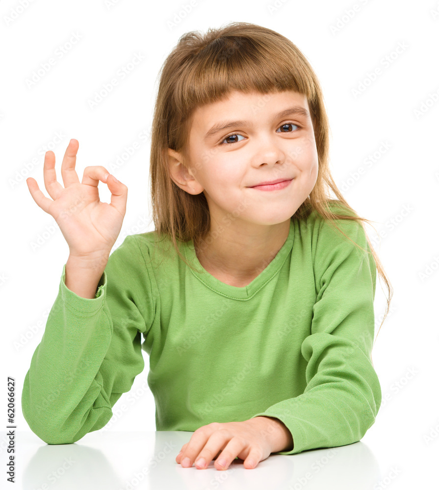 Happy little girl is showing OK sign Happy little girl is showing OK sign