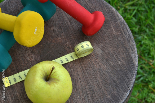 Apple with tape measure and weights
