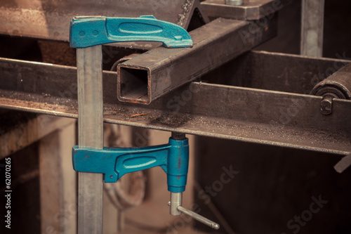 screw clamp tools pressing metal pipe - colorized photo