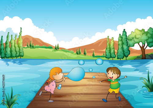 A young girl and boy playing with the bubbles