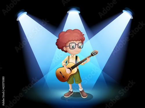 A young guitarist at the center of the stage