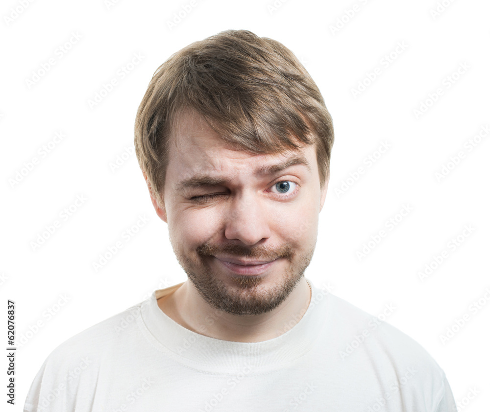 Man in t-shirt winking and smiling isolated on white. Man in t-shirt winking and smiling isolated on white.