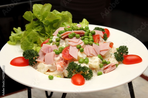 Green salad topped with sliced ham