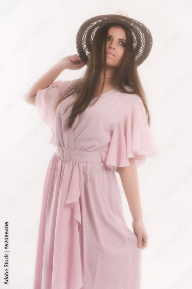Retro seventies fashion brunette woman wearing a hat and pink dr Retro seventies fashion brunette woman wearing a hat and pink dr